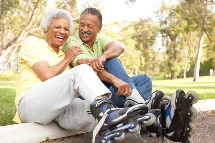 Senior Couple Putting On In Line Skates